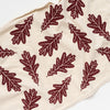 Hand-printed oak leaf tea towel in dark maroon