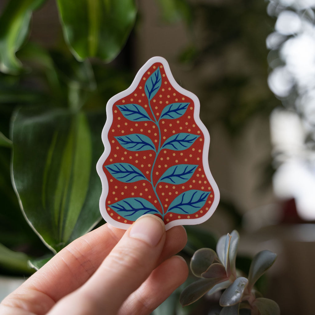 Hand holding a leaf design water bottle sticker
