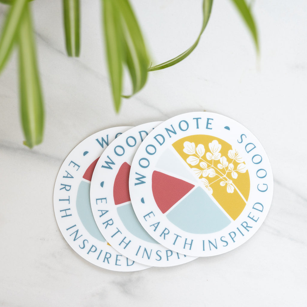 Round vinyl Woodnote logo stickers on marble